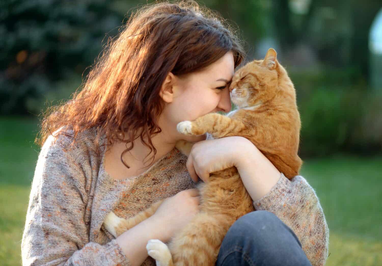 cat cuddling with lady